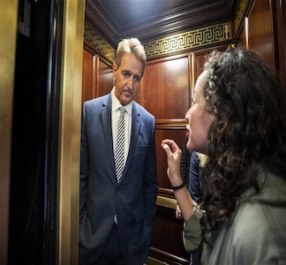 A woman yelling at a man in an elevator.
