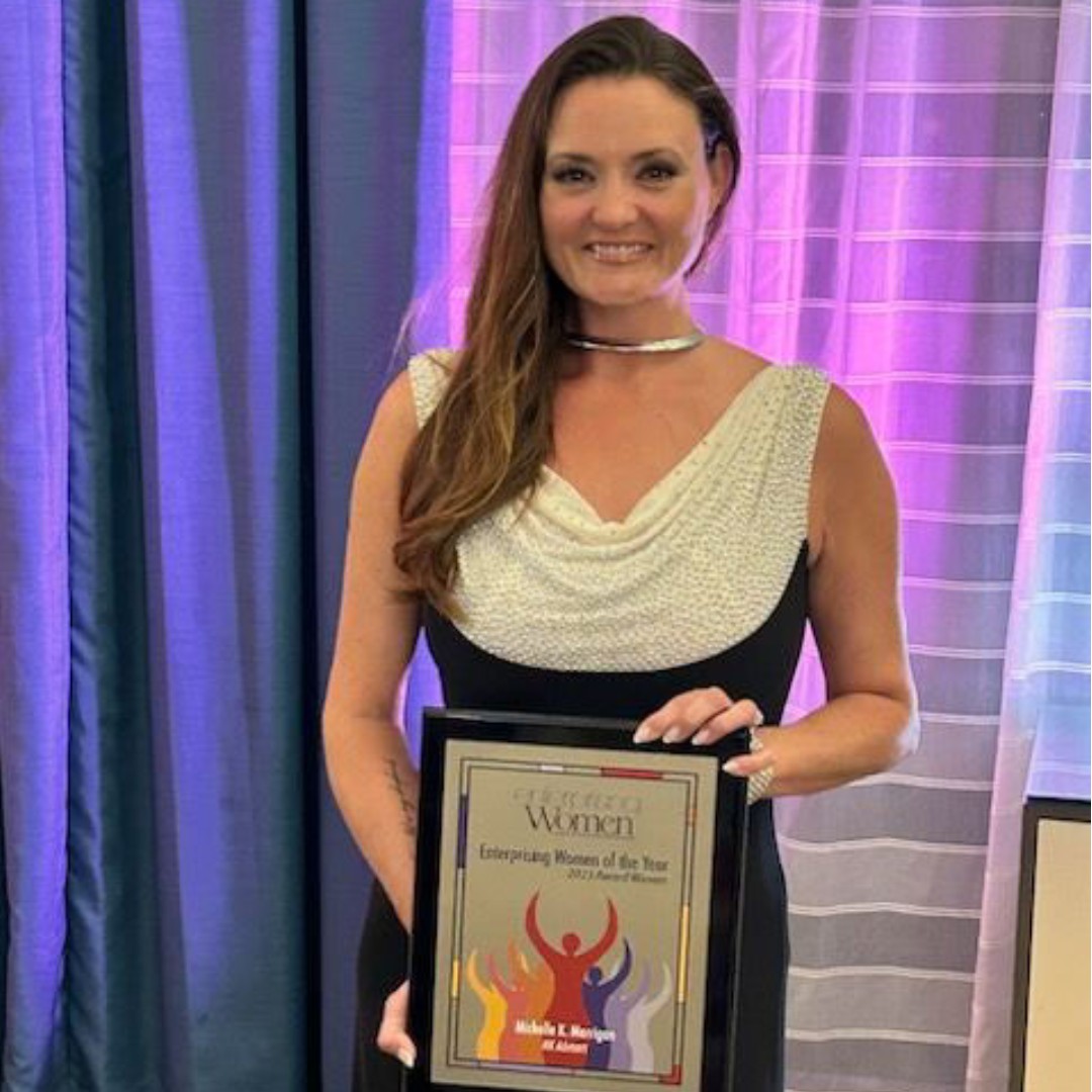 Michelle Klassen Merrigan holding Enterprising Woman Award